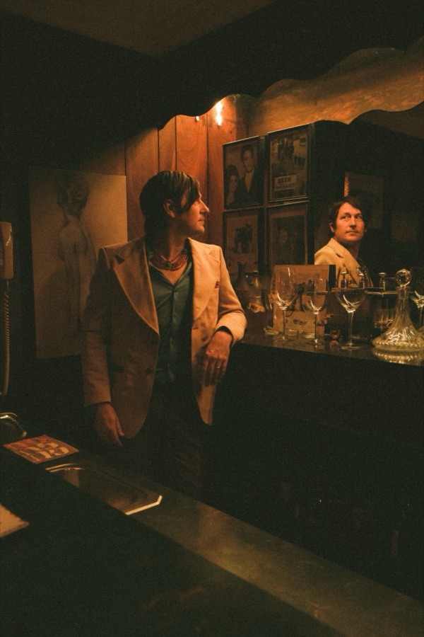 Jonathan Sexton at a wood-paneled bar in warm lamplight.